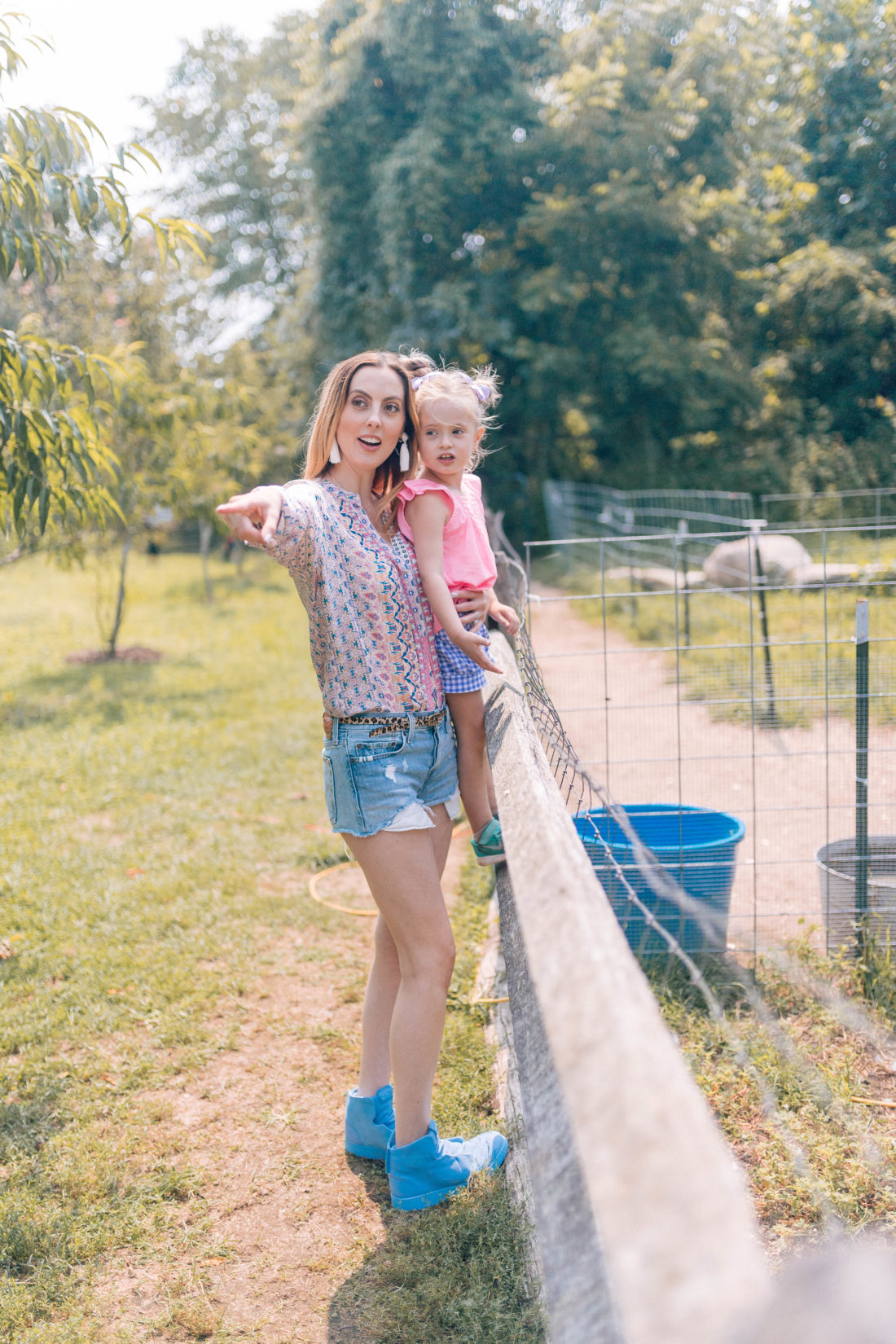 Eva Amurri Martino stands by a fence with four year old daughter Marlowe and peers in to an alpaca pen at a local connecticut farm