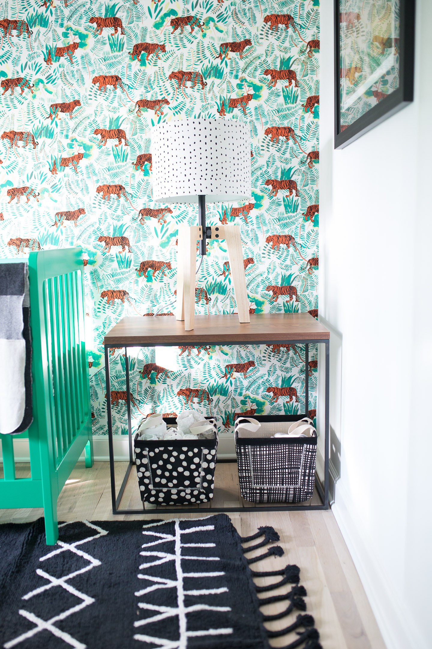Major Martino's nursery features black and white tribal patterns with kelly green accents and a vibrant tiger wallpaper