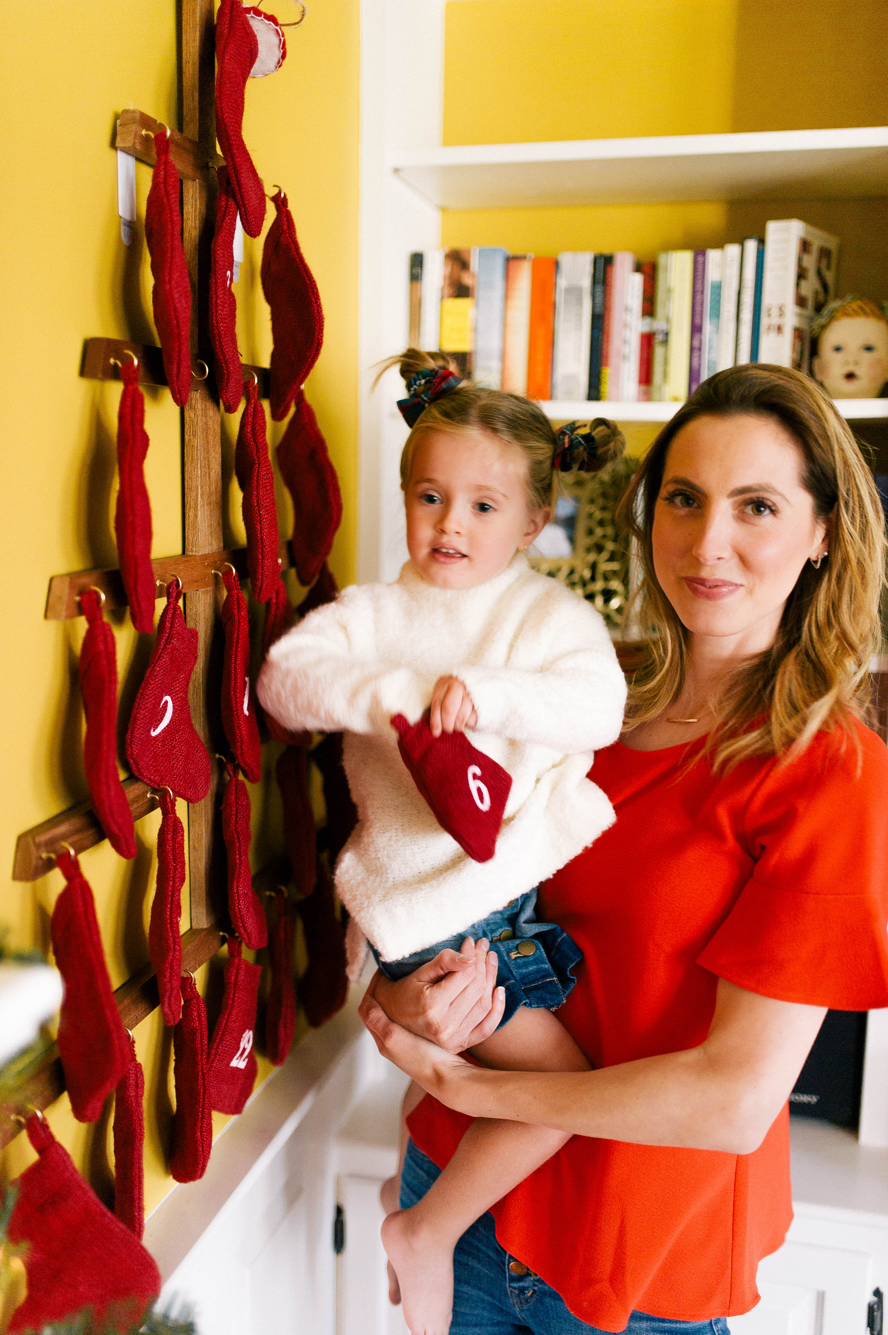Eva Amurri helps three year old daughter Marlowe unwrap a day of her Advent Calendar