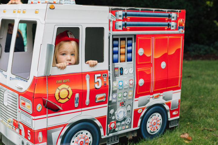 A partygoer at Marlowe Martino's 4th birthday party inside of Melissa & Doug fire truck