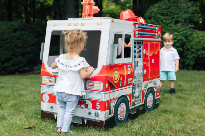 A partygoer at Marlowe Martino's 4th birthday party inside of Melissa & Doug fire truck