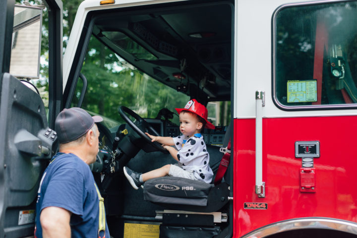 Eva Amurri Martino's son Major sitting in a firetruck with at his sister Marlowe's 4th birthday party