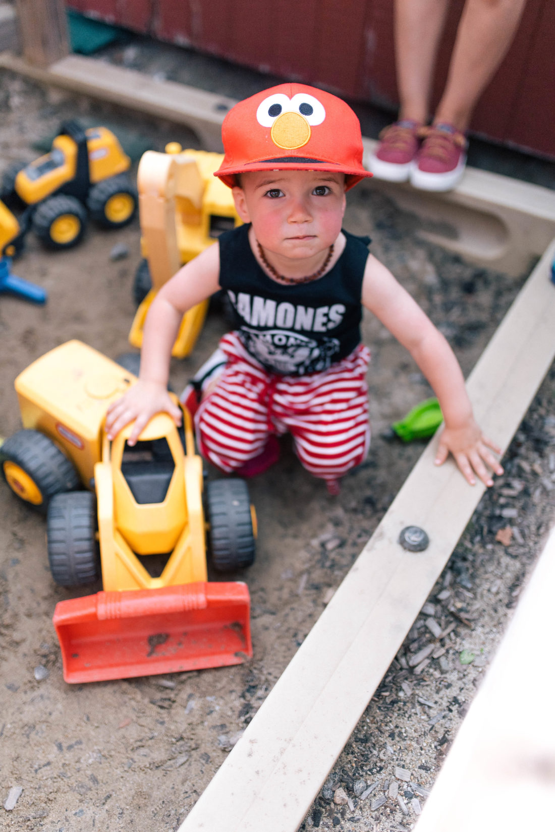Major Martino wears an Elmo hat, and a ramones tank top, and plays in the sand at a playground in Connecticut