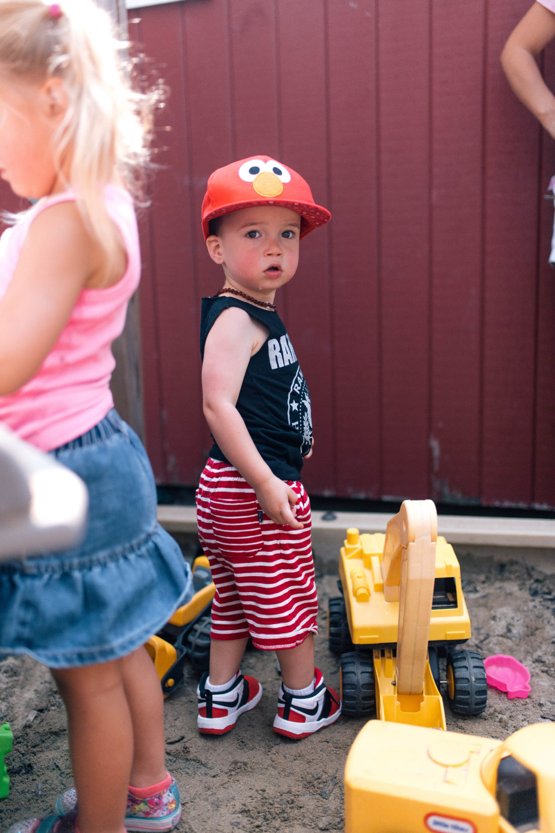 Major Martino stands in the sand box in Connecticut, wearing striped shorts and an elmo hat