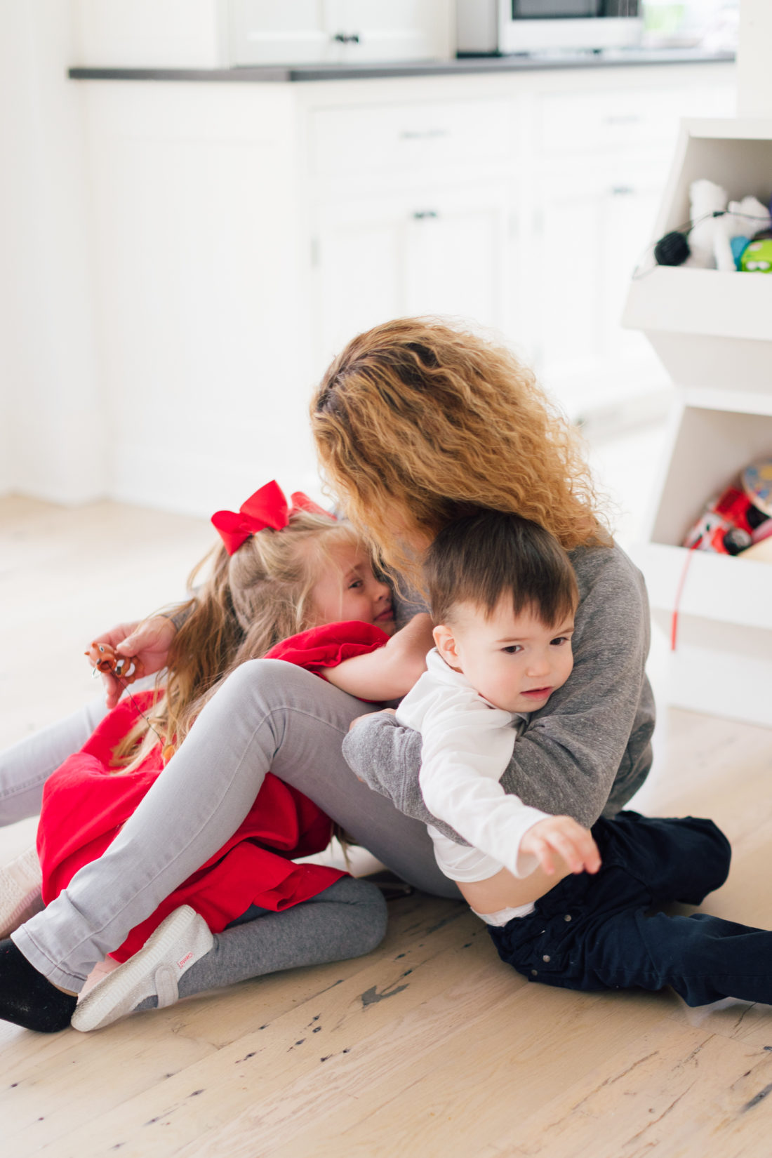 Marlowe and Major Martino snuggle their nanny in the family room of their connecticut home
