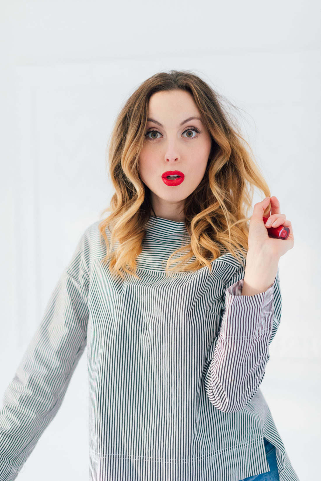 Eva Amurri Martino wears a striped boatneck top, and the perfect holiday red shade of lipstick