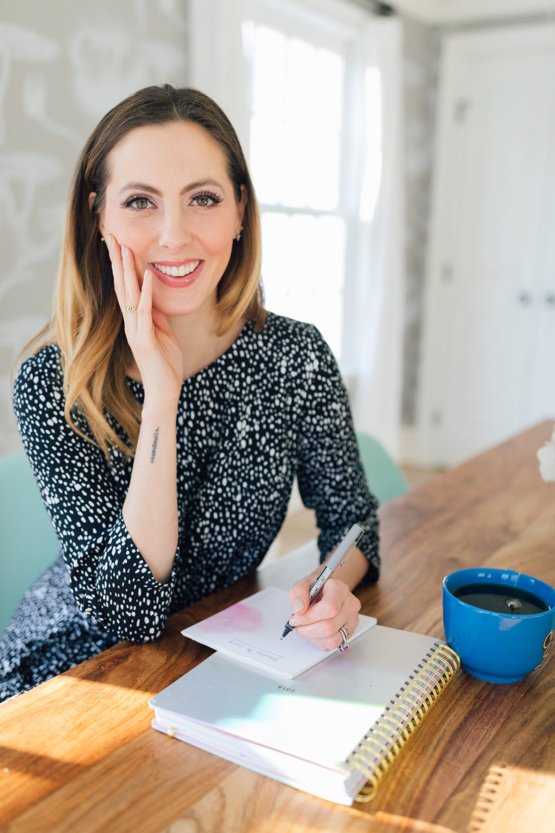 Eva Amurri Martino sits at her dining room table and writes down her intentions for the new year