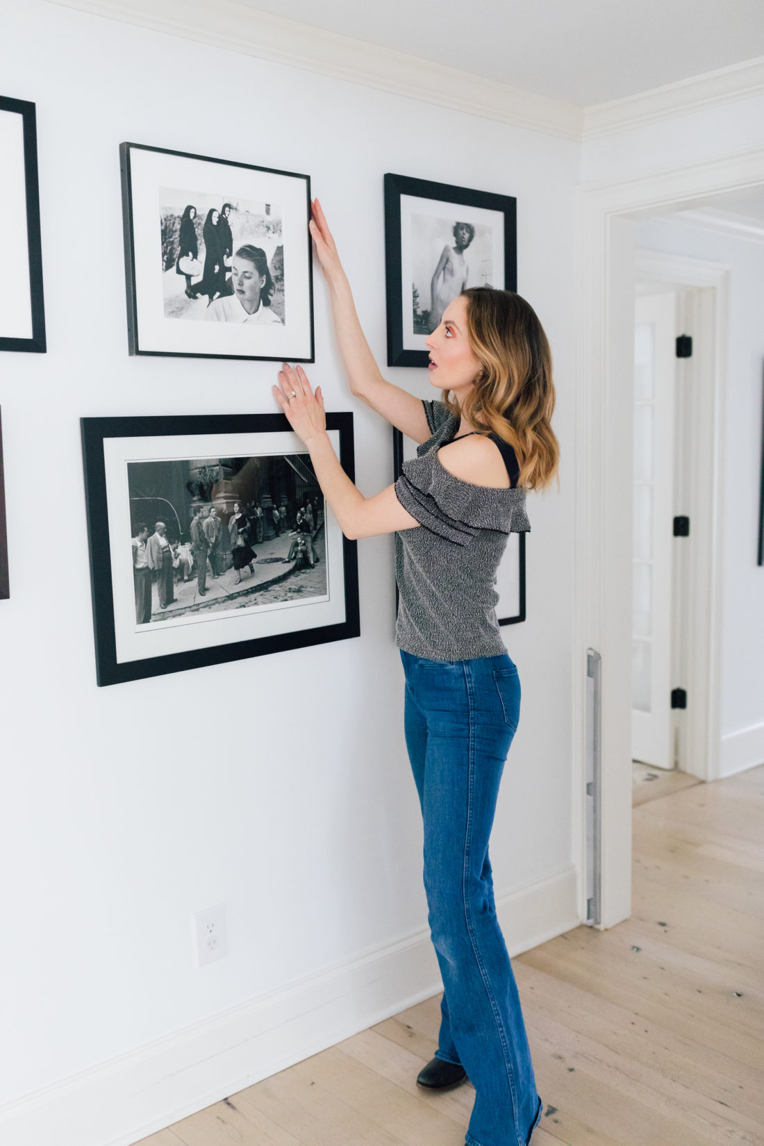 Eva Amurri Martino stands in the hallways of her connecticut home and selects a black and white photograph from the wall as she decides what to pack and what to give away before her family's move