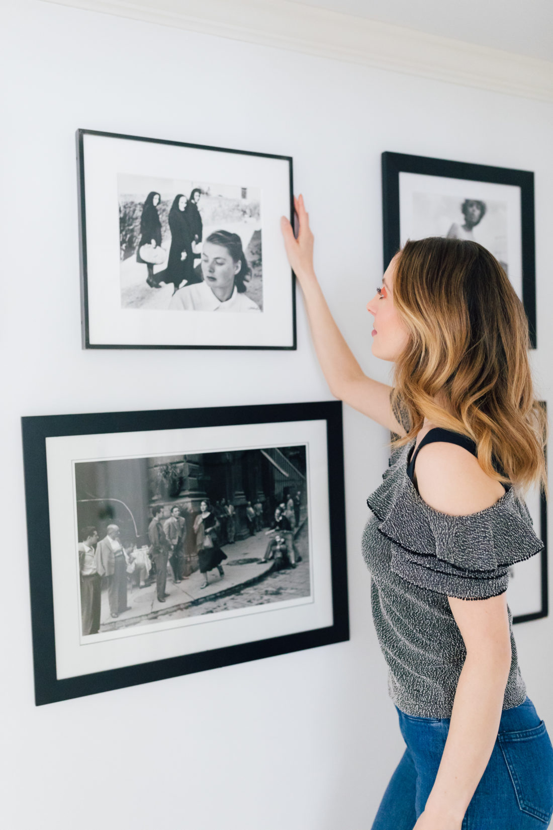 Eva Amurri Martino stands in the hallways of her connecticut home and selects a black and white photograph from the wall as she decides what to pack and what to give away before her family's move
