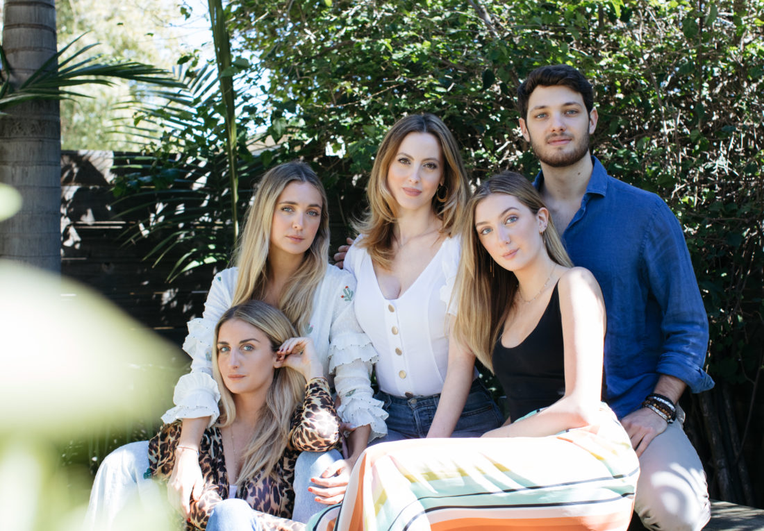 Eva Amurri Martino and her siblings on her father's side sit for a portrait in the garden of a venice bungalow
