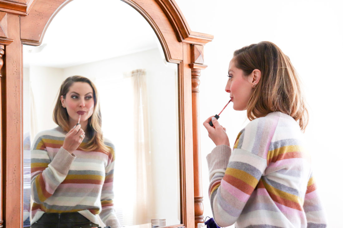 Eva Amurri Martino of Happily Eva After gets ready to begin her day by putting on lipgloss in the mirror.