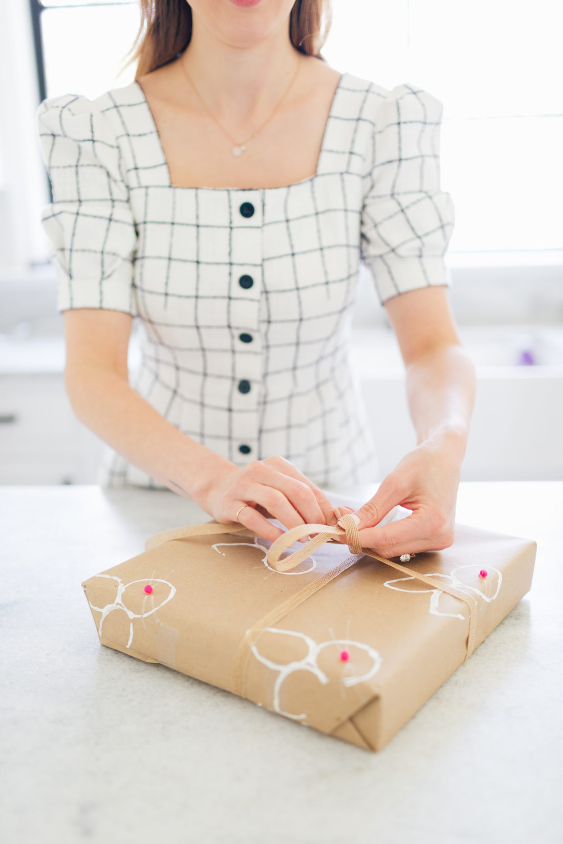 Eva Amurri Martino wraps a gift in stamped Easter wrapping paper
