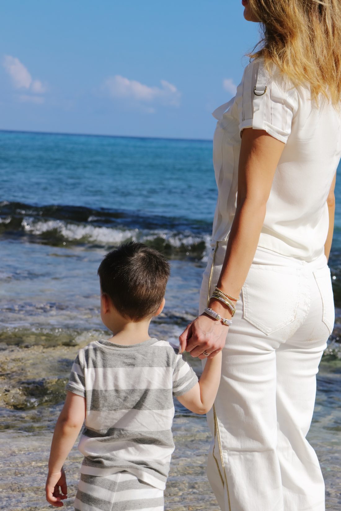 Eva Amurri Martino holds her son Major's hand on the beach in Connecticut