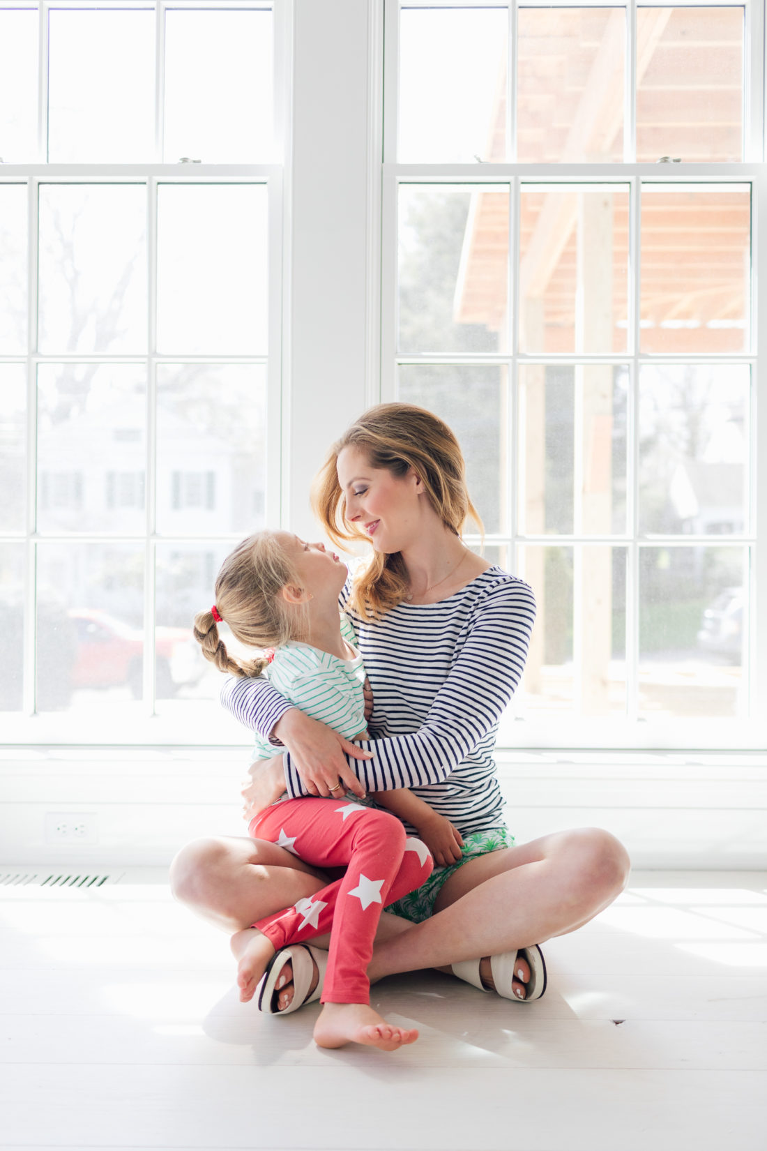 Eva Amurri Martino of Happily Eva After cradles her daughter Marlowe on the floor of their new home in Connecticut