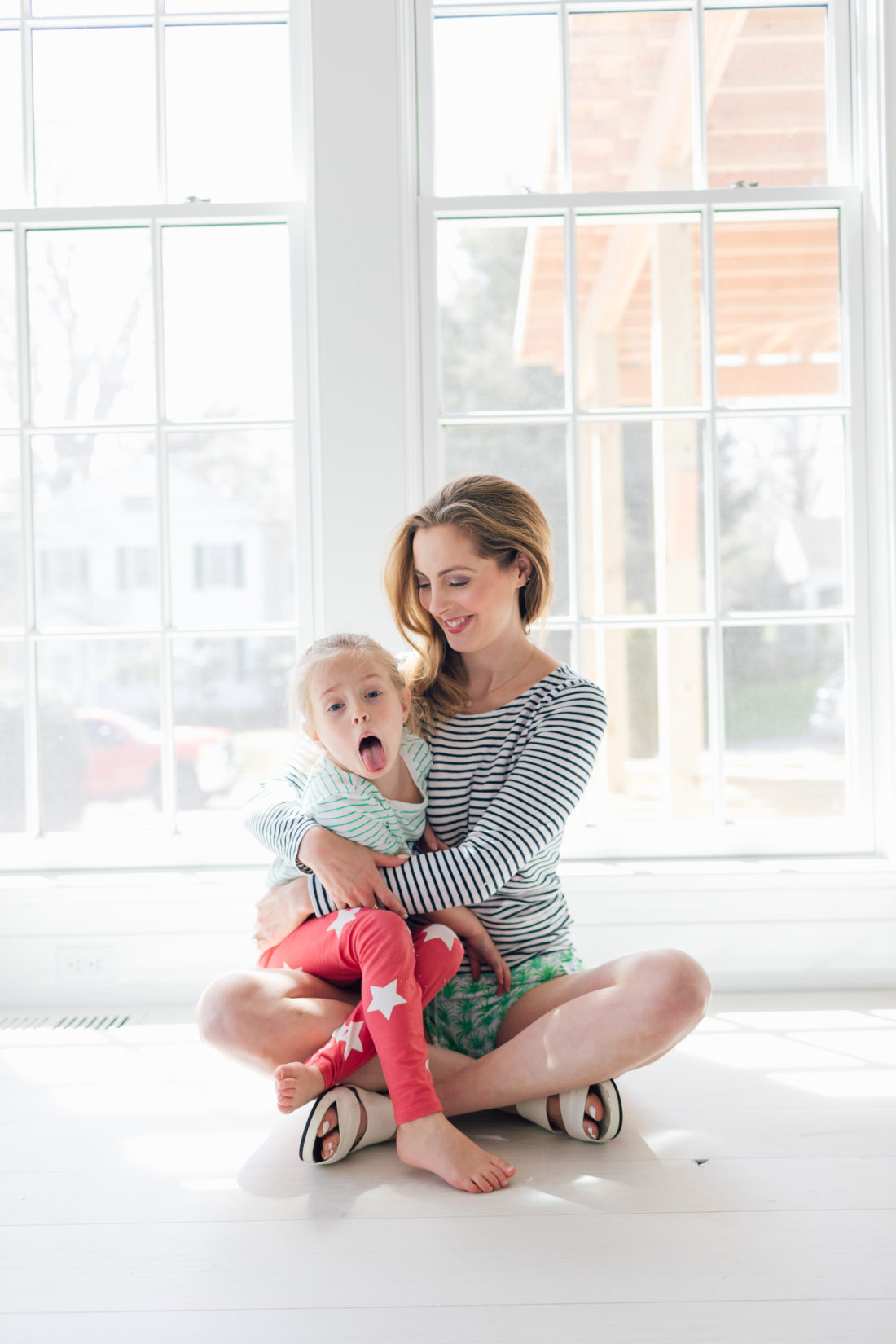 Eva Amurri Martino of Happily Eva After cradles her daughter Marlowe on the floor of their new home in Connecticut