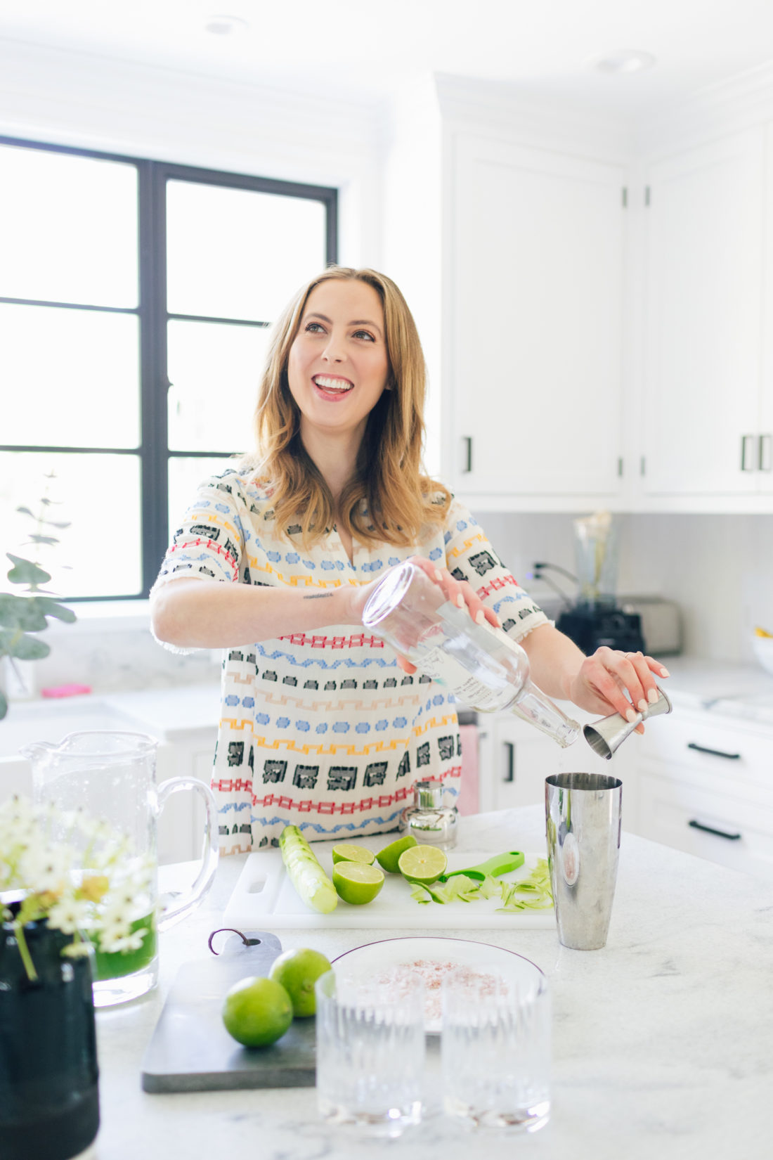 Eva Amurri Martino of Happily Eva After pour tequila into a cocktail shaker for cucumber margaritas
