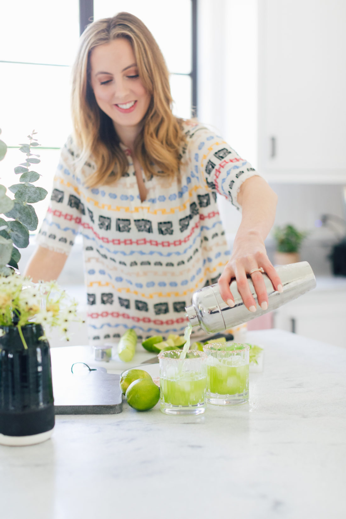 Eva Amurri Martino of Happily Eva After pours cucumber margaritas into a glass at her home in Connecticut