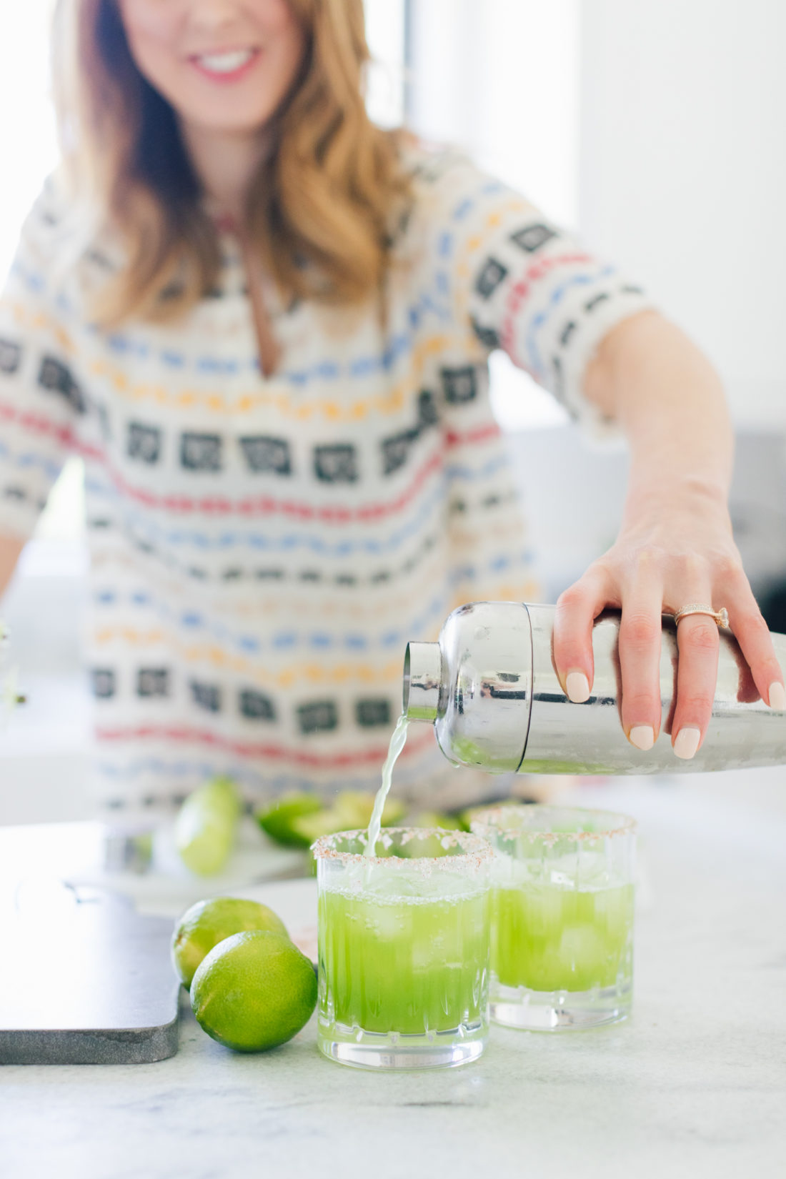 Eva Amurri Martino of Happily Eva After pours cucumber margaritas into a glass at her home in Connecticut