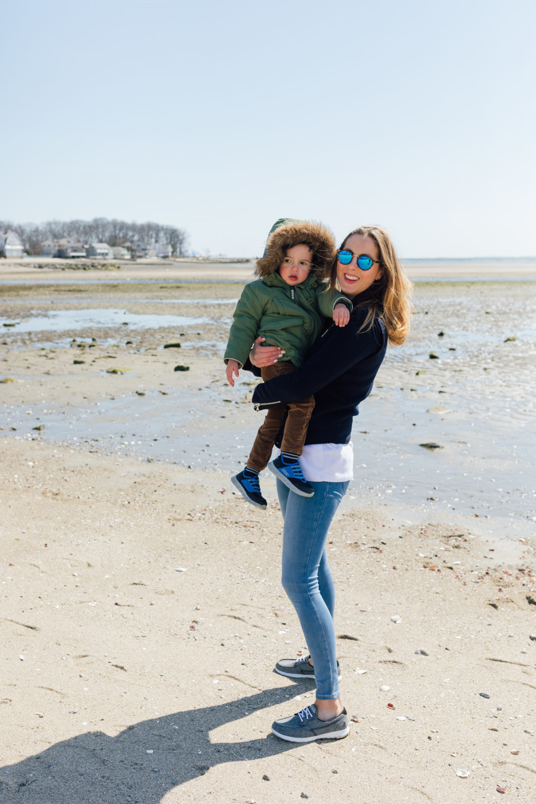 Eva Amurri Martino of Happily Eva After wears Sketchers GoWalk Lite Isla Boat Shoe with her son Major on the beach