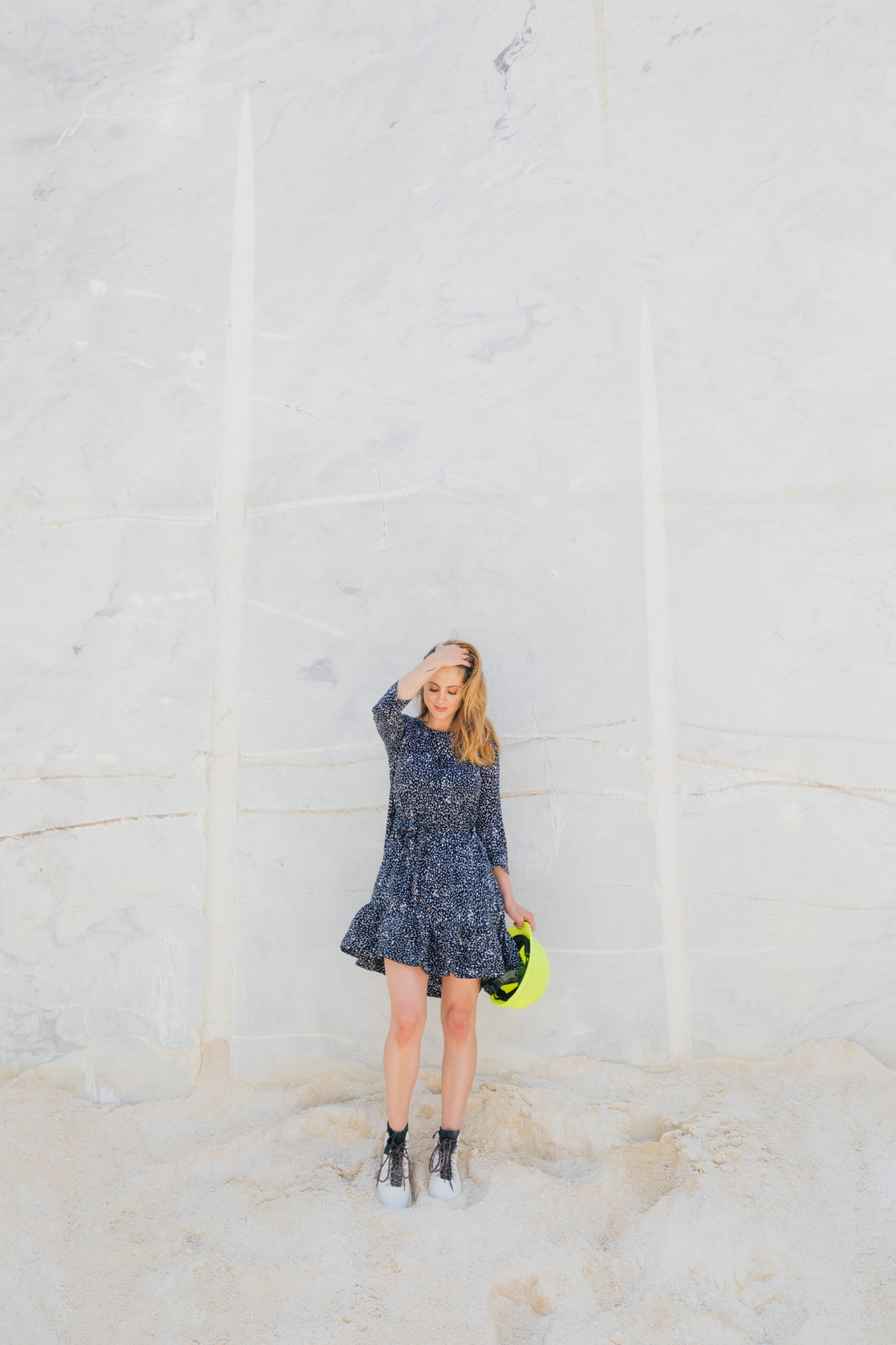 Eva Amurri Martino stands in front of a giant slab of marble at the Polycor quarry in Georgia