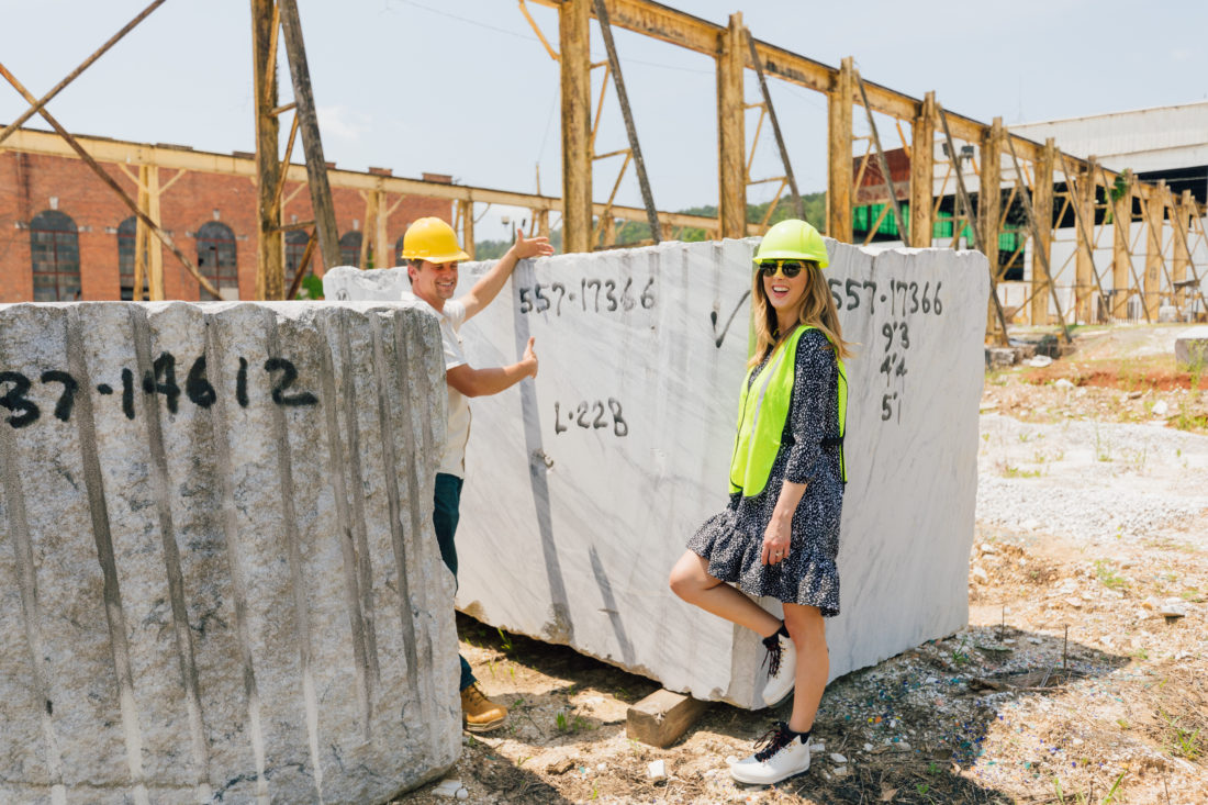 Eva Amurri Martino stands in front of a giant slab of marble at the Polycor quarry in Georgia
