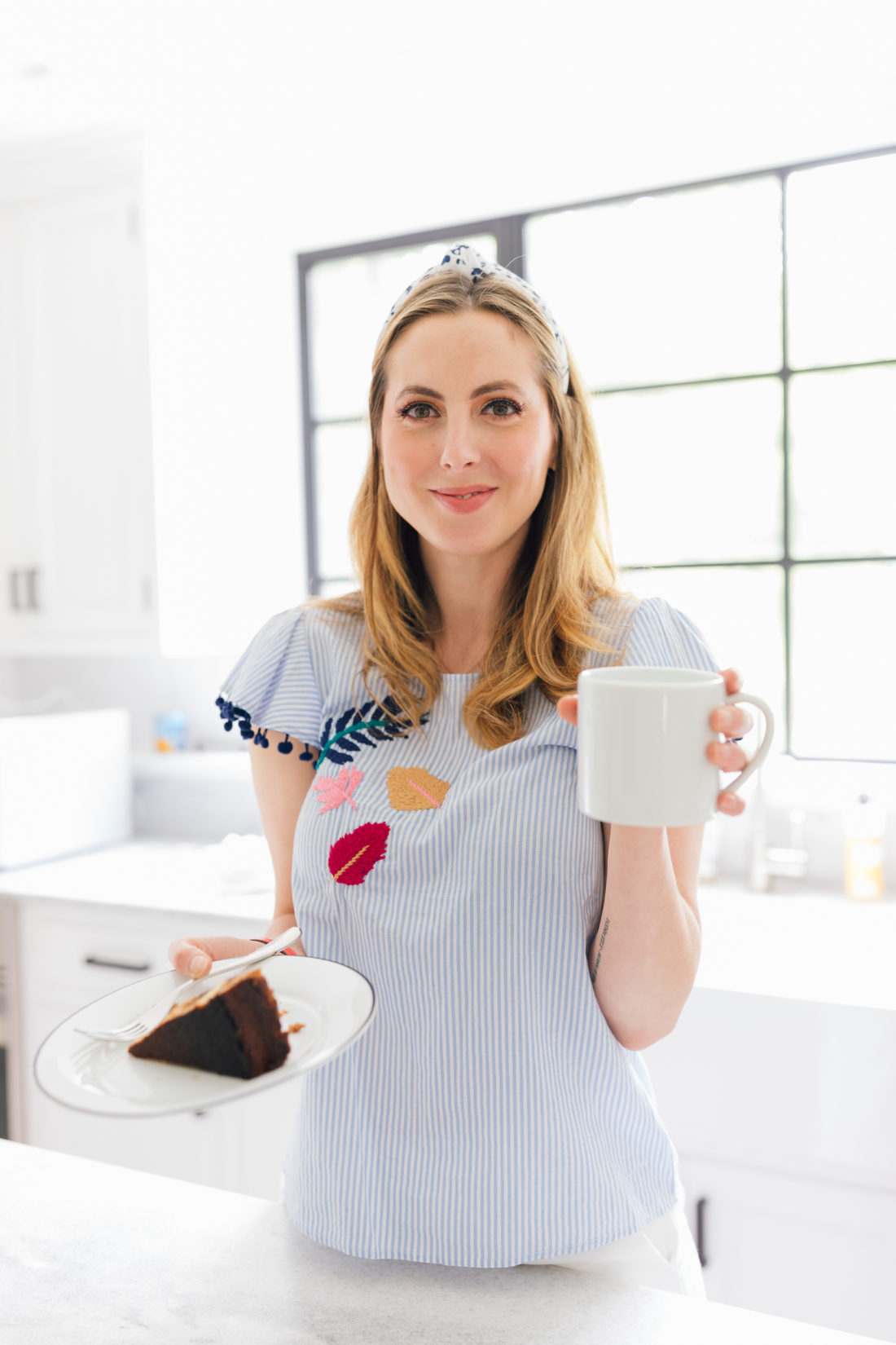 Eva Amurri Martino holds a slice of coffee cake and a cup of coffee at her home in Connecticut