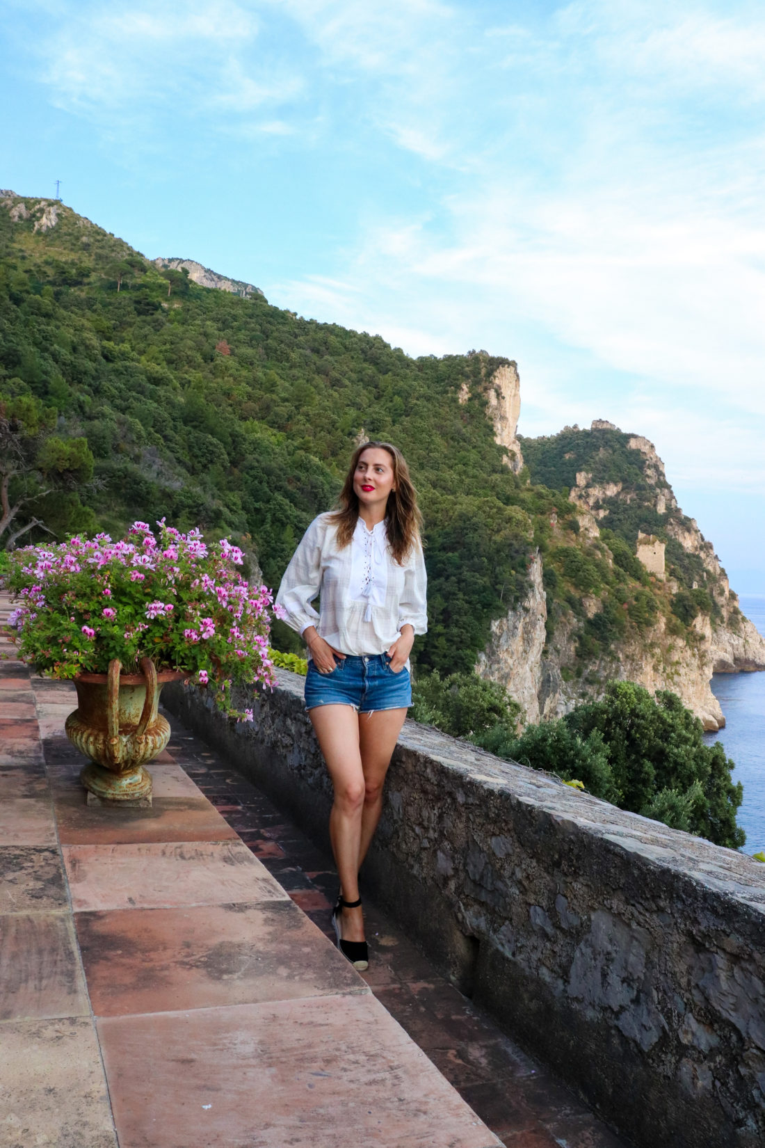 Eva Amurri Martino stands on the edge of a cliff in the Amalfi Coast