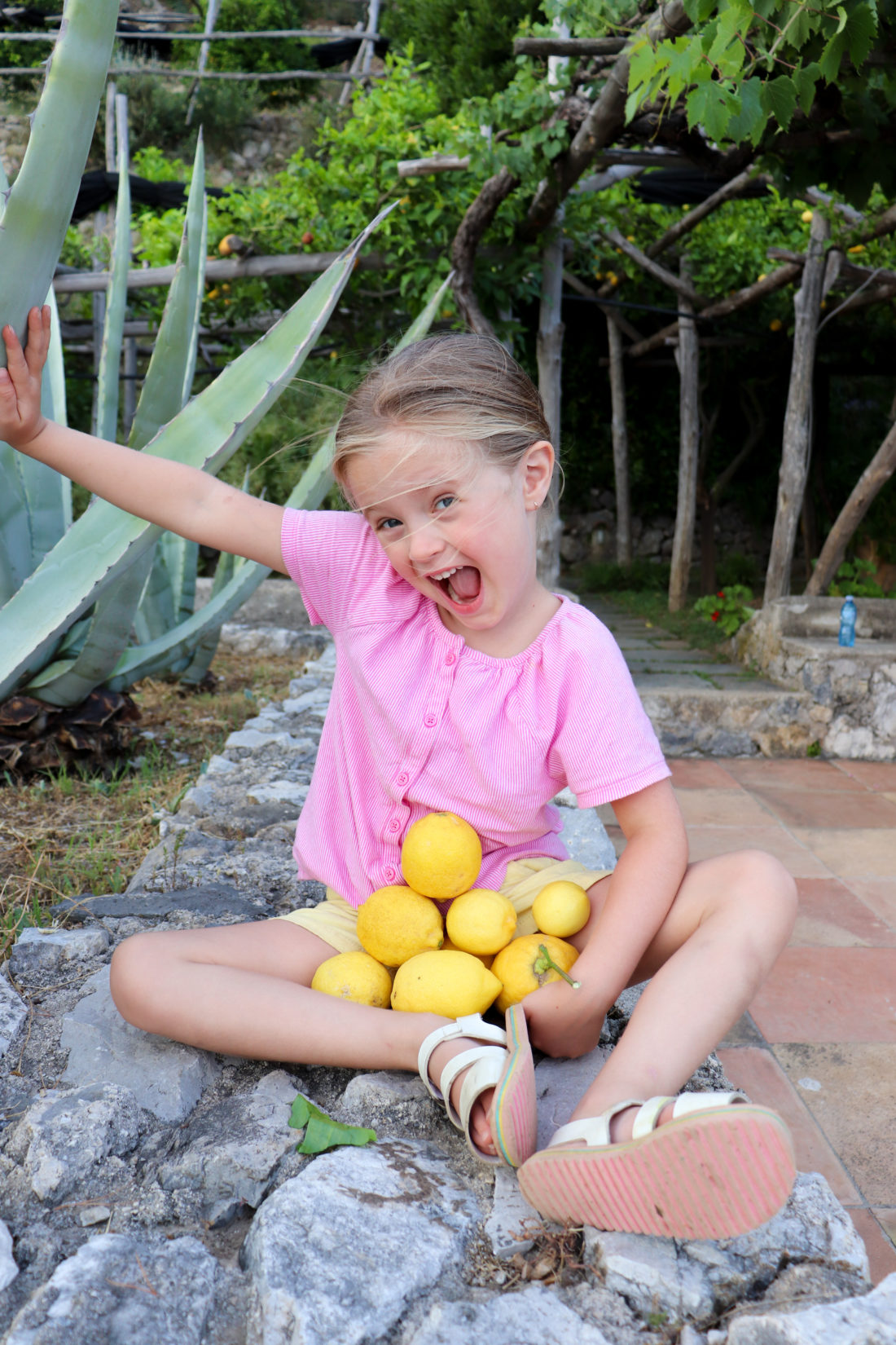 Eva Amurri Martino's daughter Marlowe collects lemons in Amalfi