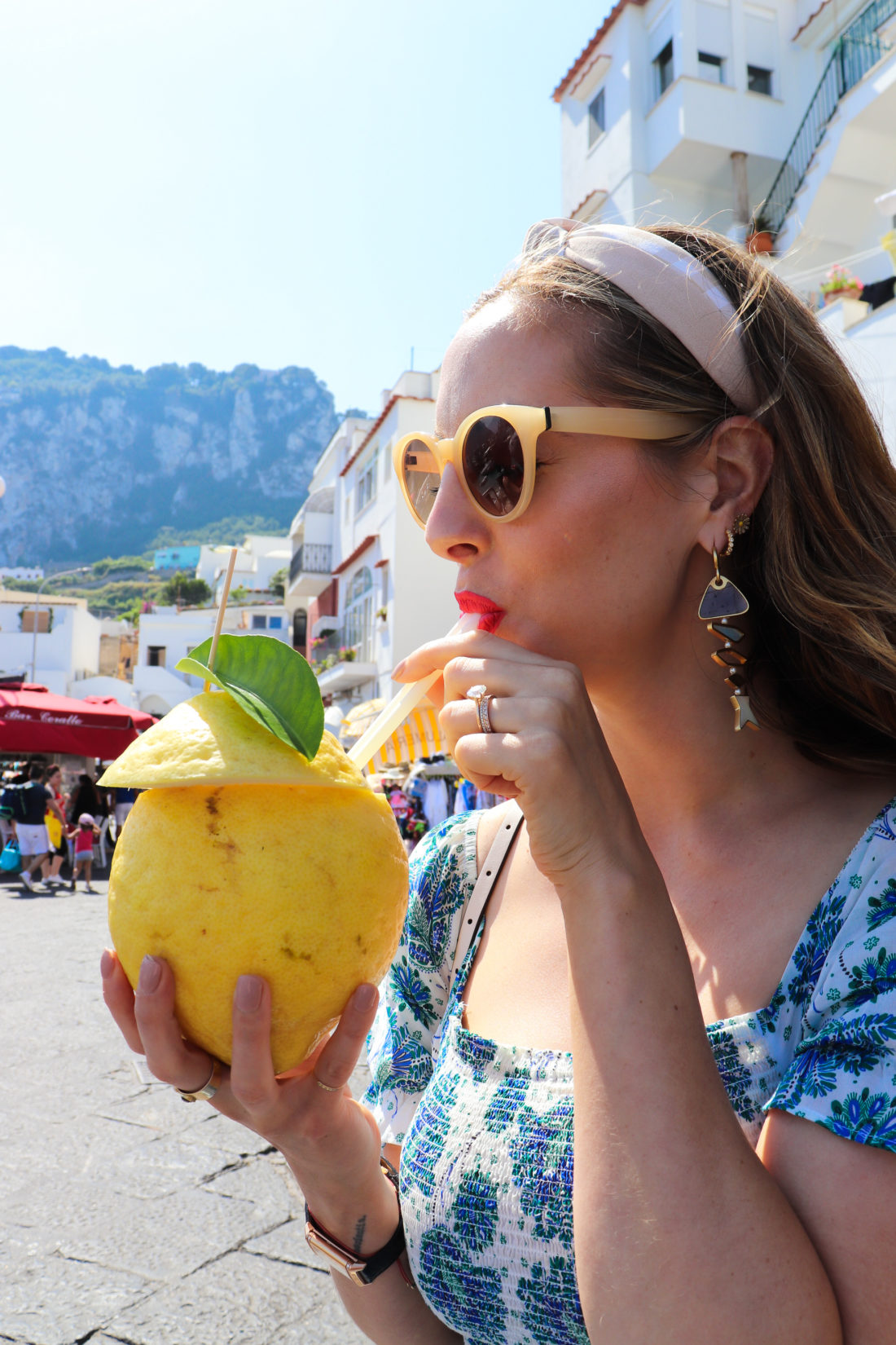Eva Amurri Martino sips a cocktail from a giant lemon in Amalfi