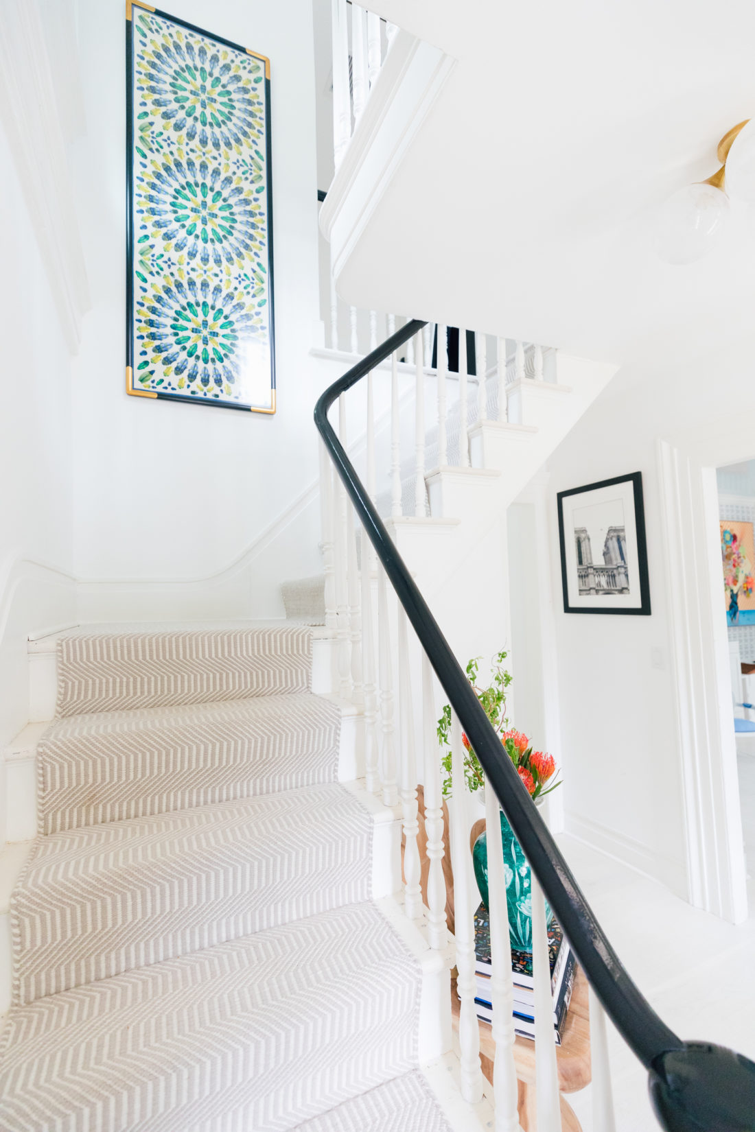A framed Tory Burch scarf sits atop the stairway in Eva Amurri Martino's entry way