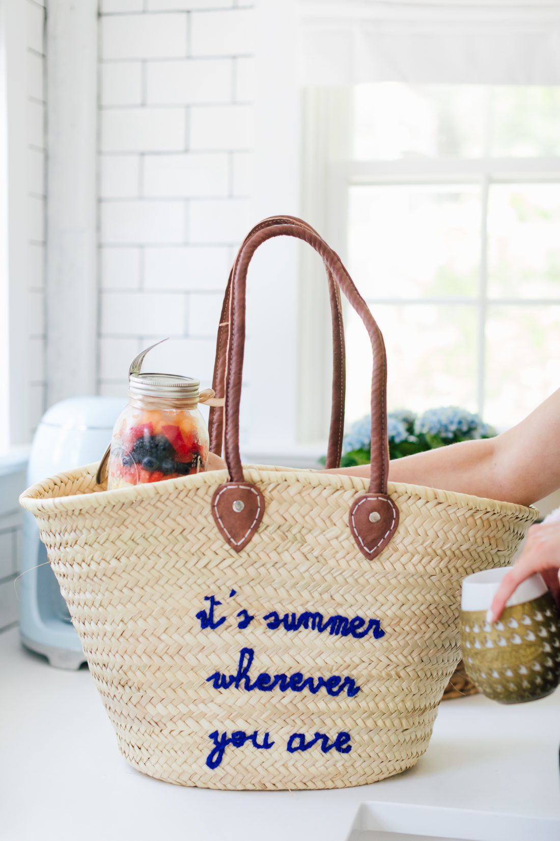 A straw bag that says It's Summer Whenever