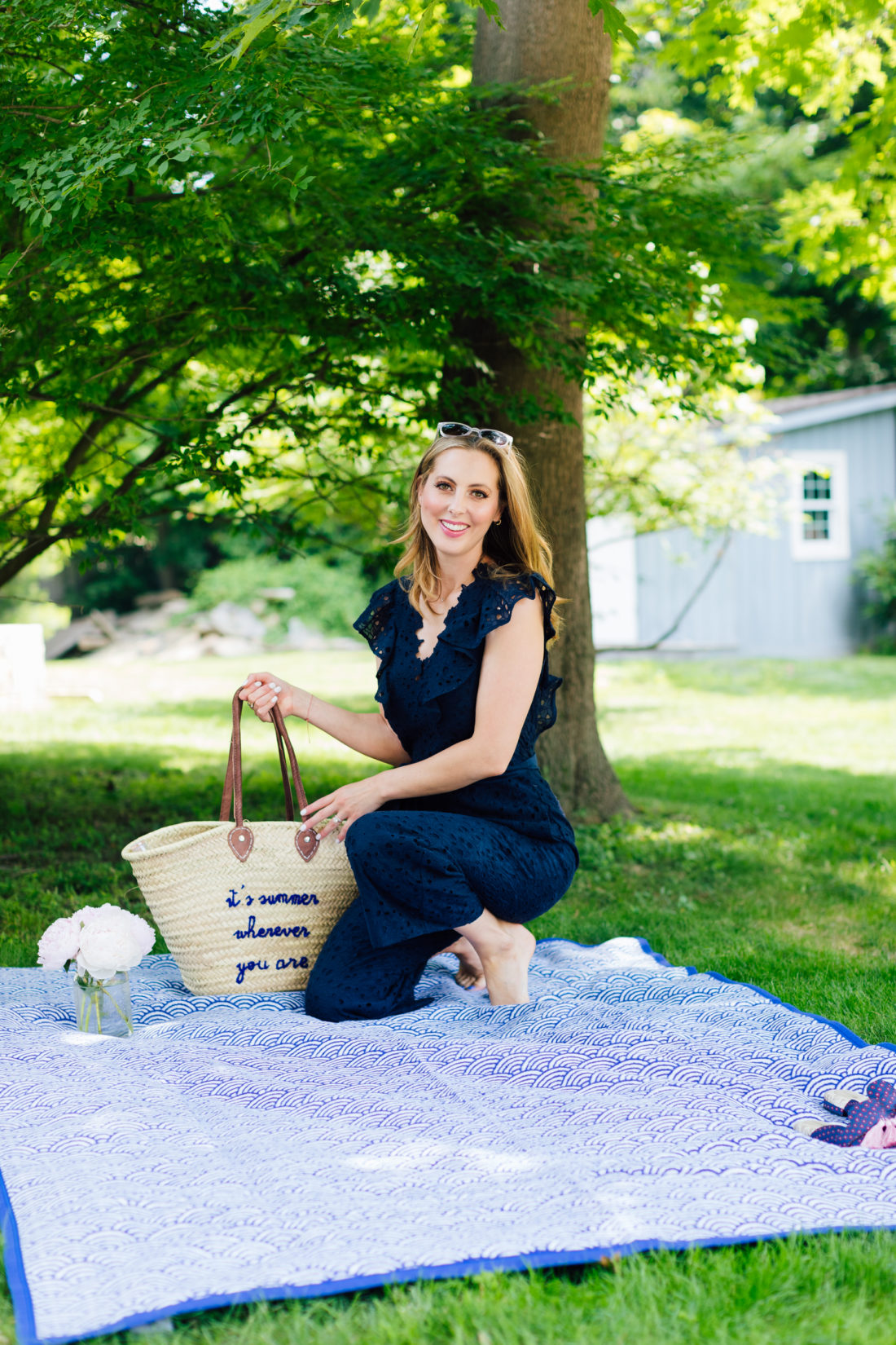 Eva Amurri Martino kneels on a picnic blanket in her backyard