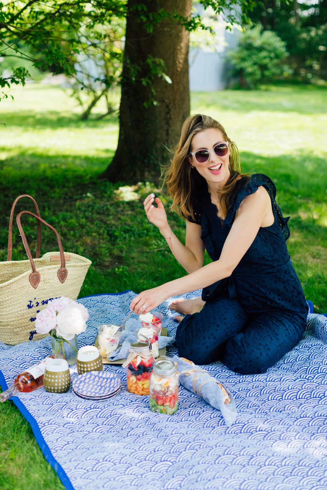 Eva Amurri Martino kneels on a picnic blanket in her backyard