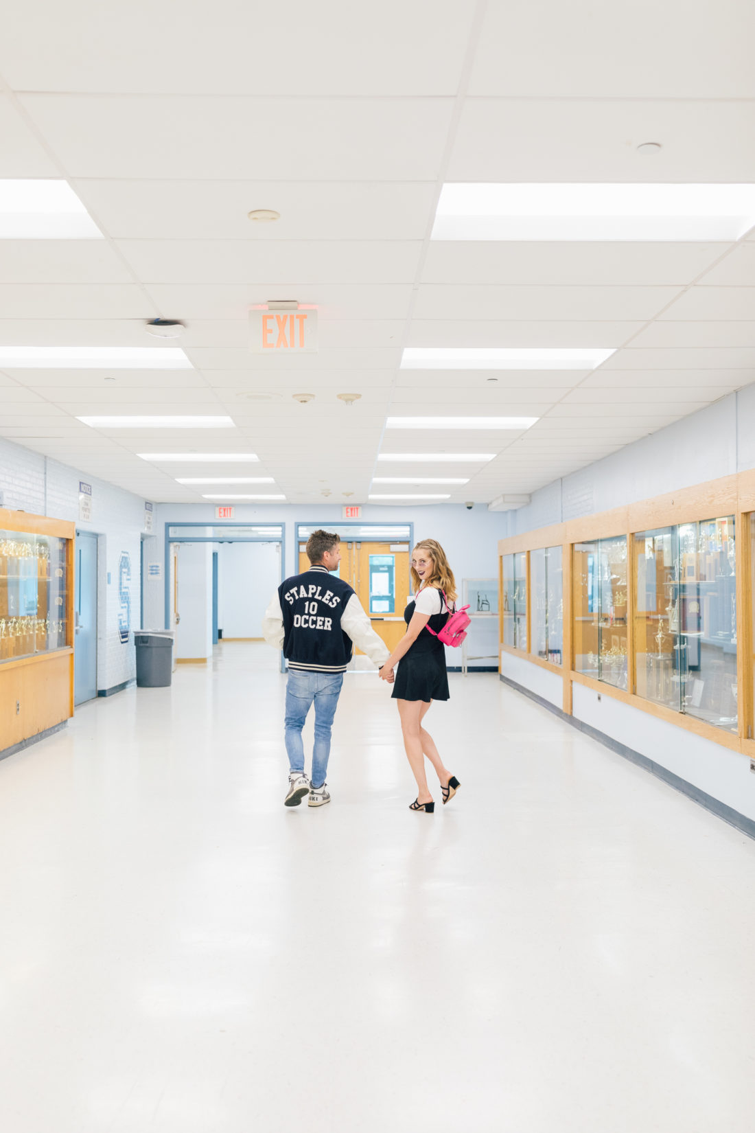 Eva Amurri Martino and husband Kyle wear 90's gear and walk through the halls of his high school