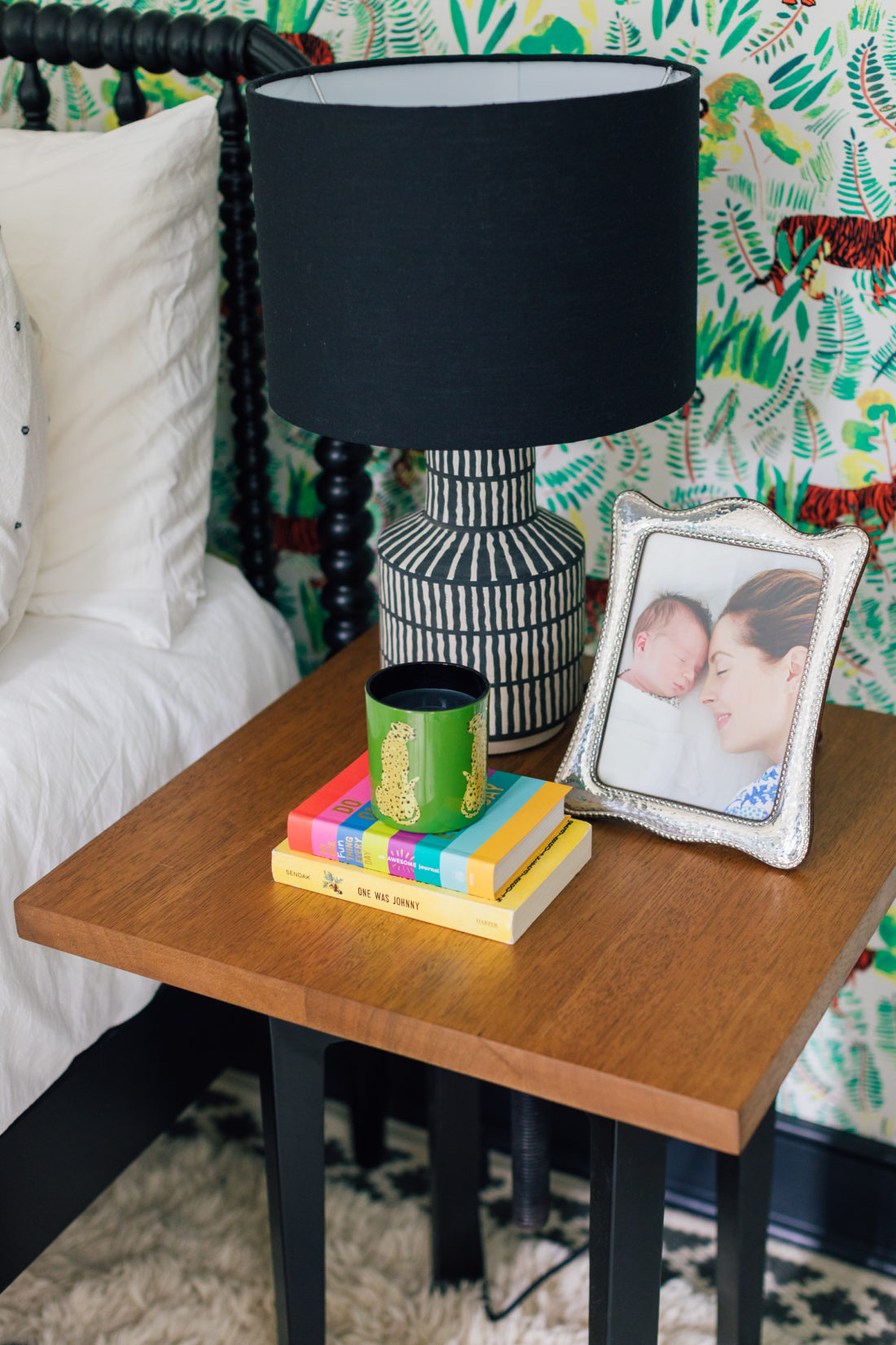 A sweet photos of Eva Amurri Martino with son Major right after his birth sits atop a wooden bedside table in his colorful new bedroom.
