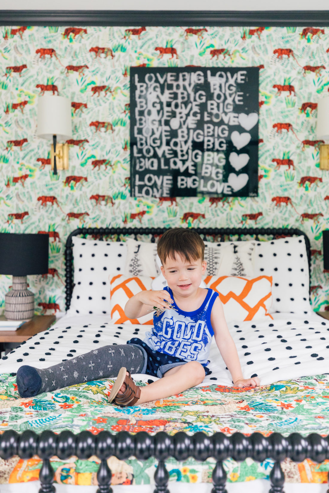 Eva Amurri Martino's son Major sits on his colorful bed in his new bedroom beneath a Kerri Rosenthal print