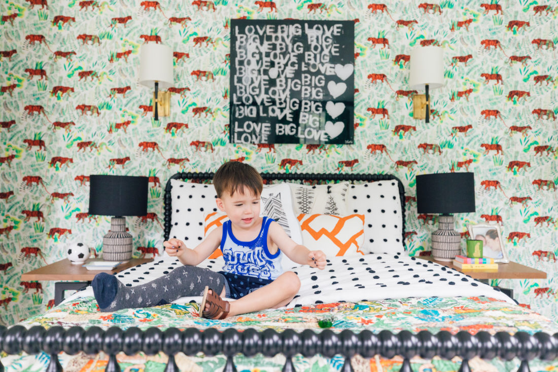 Eva Amurri Martino's son Major sits on his colorful bed in his new bedroom beneath a Kerri Rosenthal print