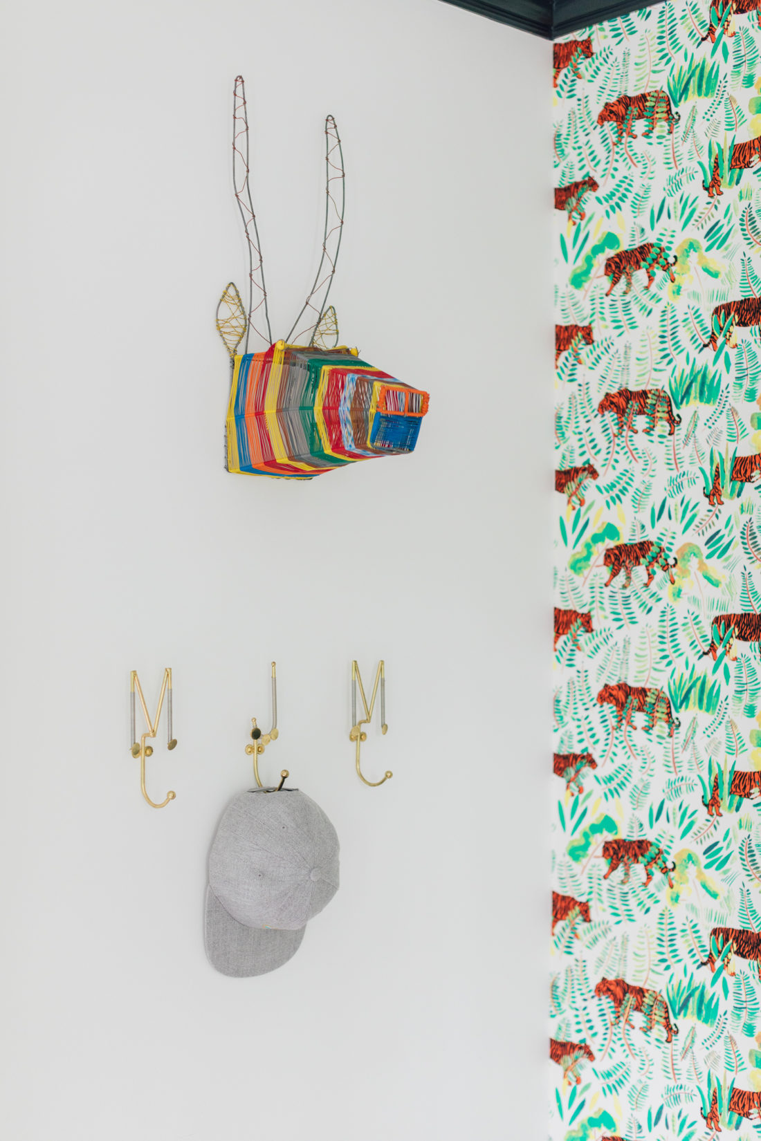 A colorful wall hanging with initial hooks in Eva Amurri Martino's son Major's new room