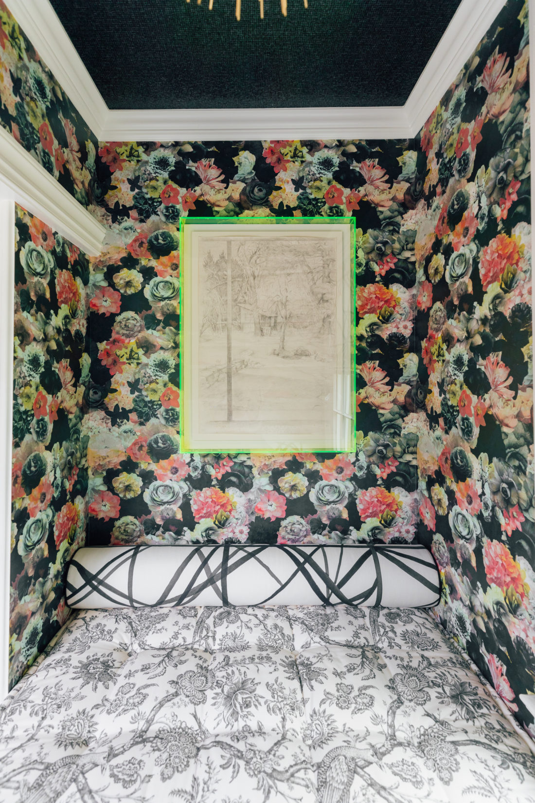 A historic painting framed in a green neon acrylic frame in the snuggle nook of Eva Amurri Martino's Connecticut home