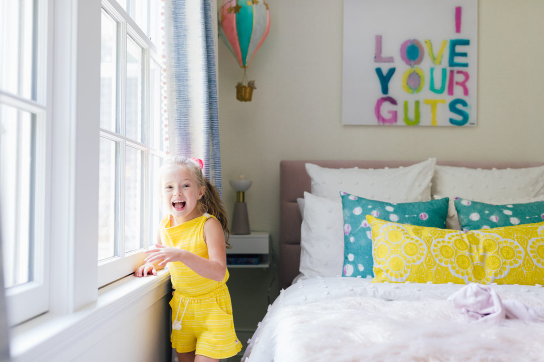 Marlowe Martino looks out the window of her colorful new bedroom
